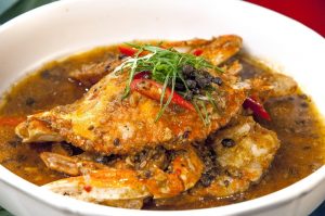 Serving of braised crab in a deep white bowl